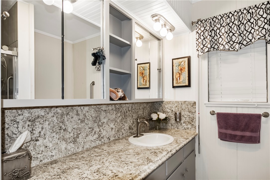 155 Harbor Circle Mathis, TX 78368 - Photo 30 of 40 a bathroom with a sink and a mirror