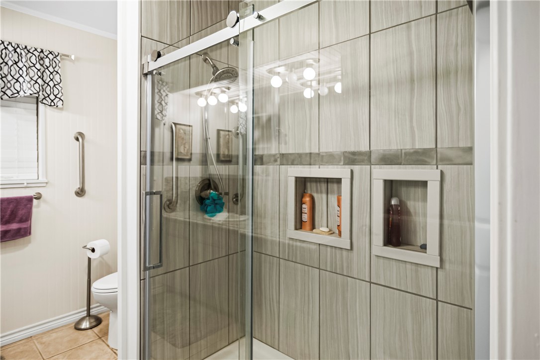 155 Harbor Circle Mathis, TX 78368 - Photo 31 of 40 a bathroom with a glass shower door and a sink