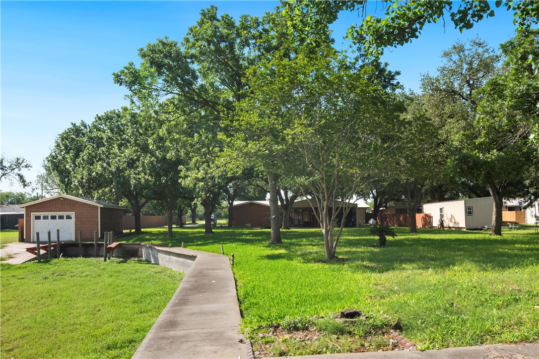 155 Harbor Circle Mathis, TX 78368 - Photo 6 of 40 a front view of a house with a yard and trees