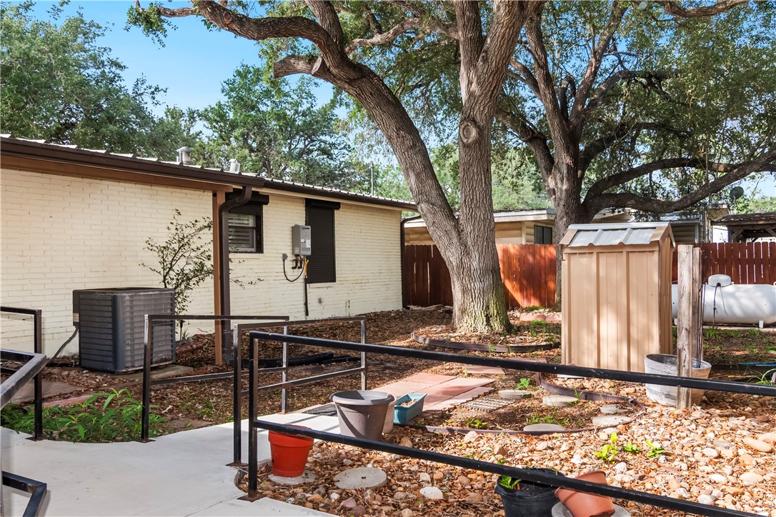 155 Harbor Circle Mathis, TX 78368 - Photo 7 of 40 a view of a backyard with wooden fence and a large tree