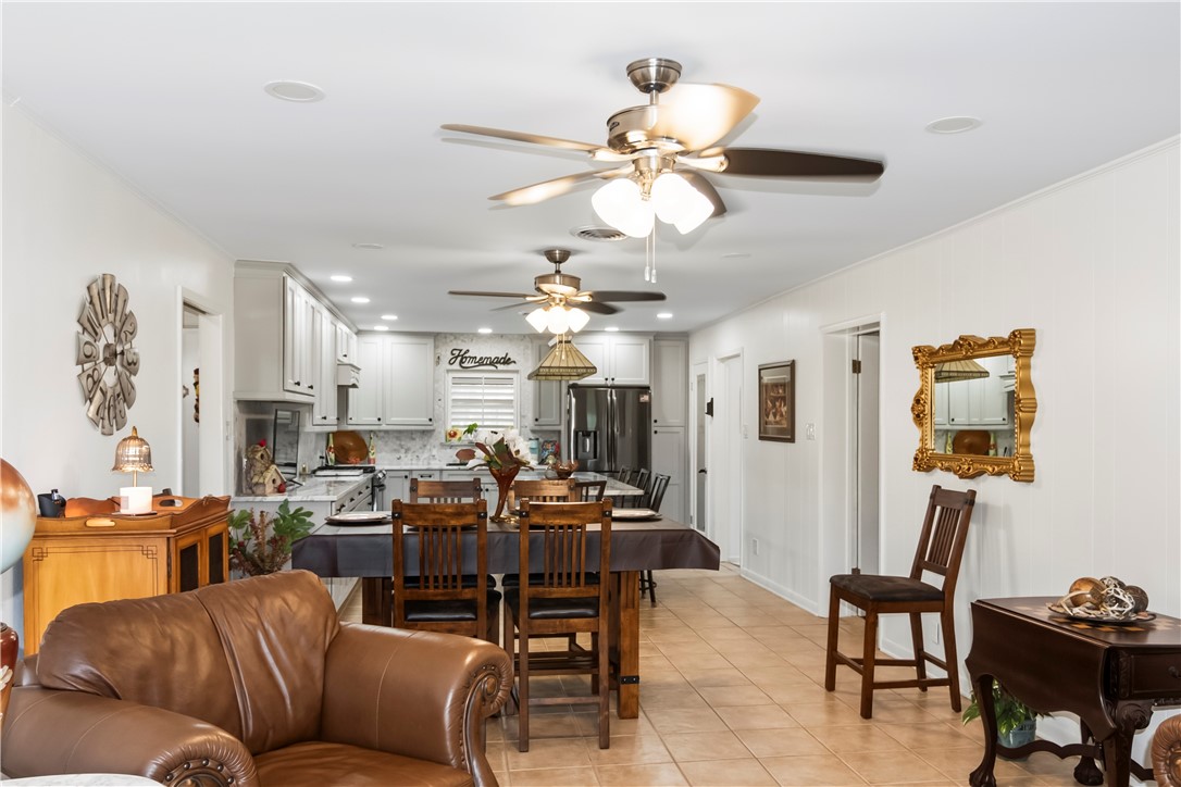 155 Harbor Circle Mathis, TX 78368 - Photo 10 of 40 a living room with furniture kitchen view and a chandelier