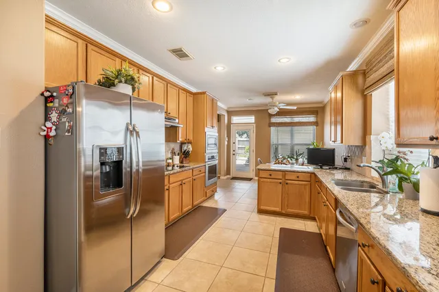 a large kitchen with stainless steel appliances lots of counter top space