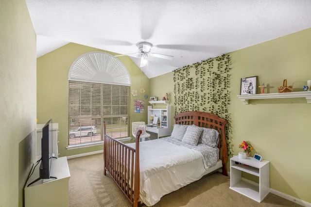 a bedroom with a bed next to a window with the outer view