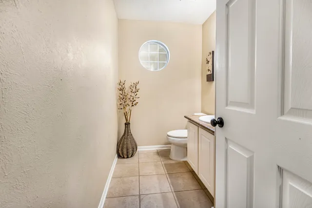 a bathroom with a toilet and a shower curtain