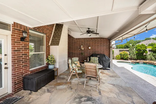 a view of a patio with a table and chairs