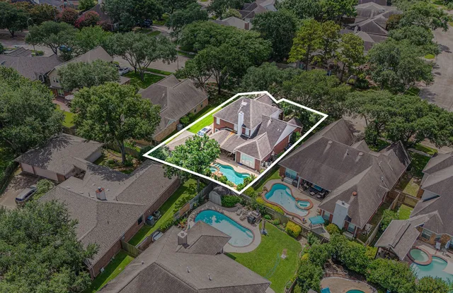 an aerial view of a house with a big yard