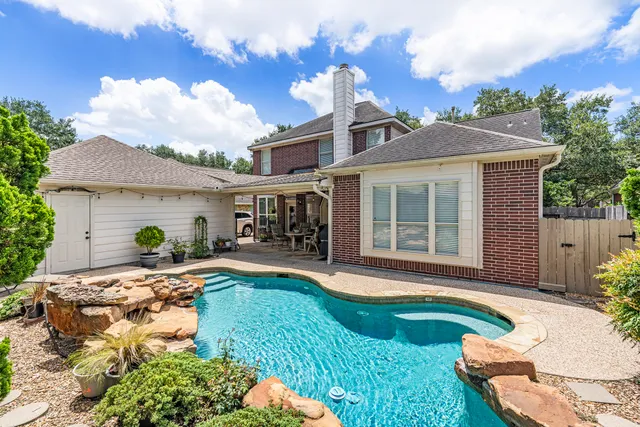 a front view of a house with swimming pool having outdoor seating