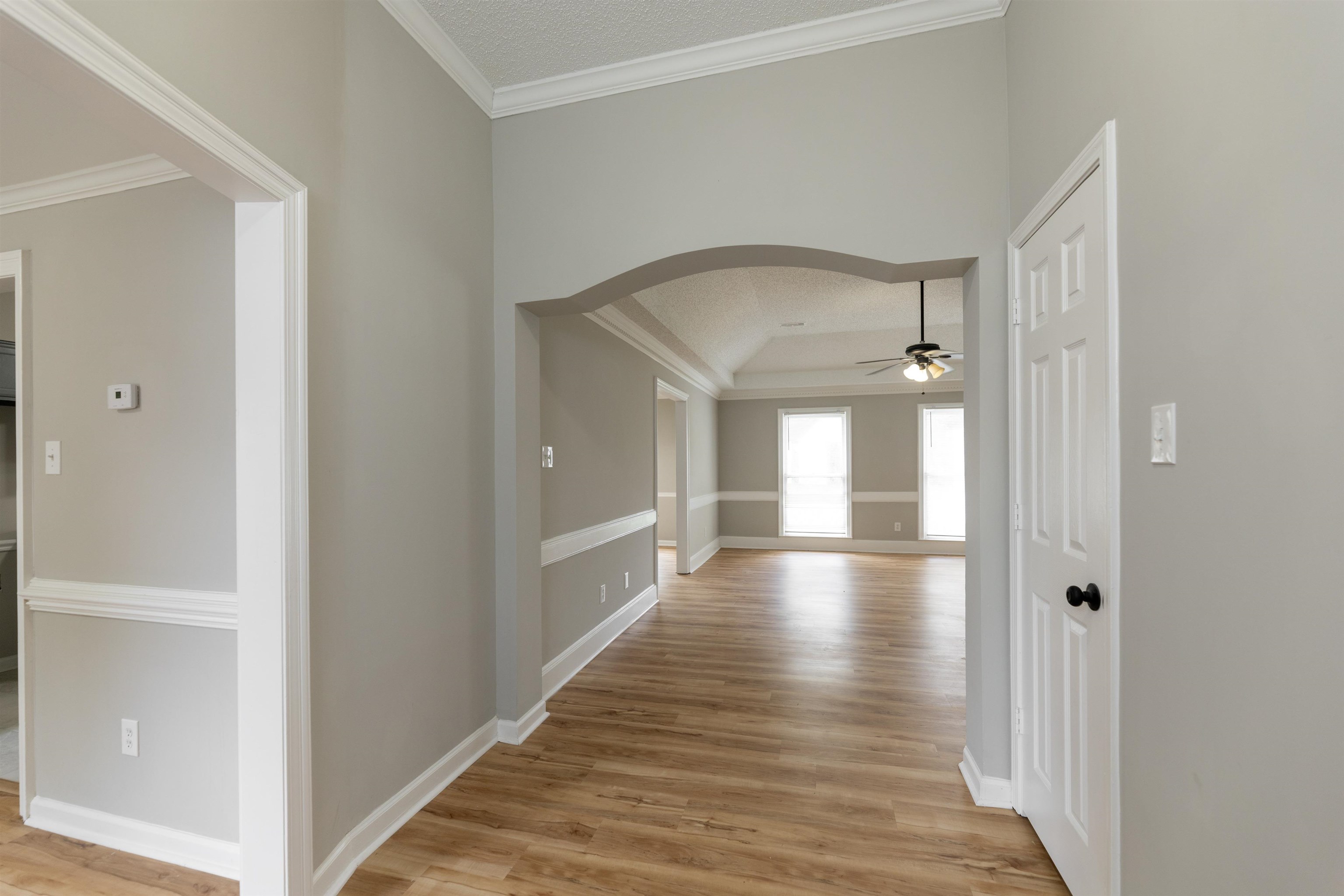 7421 Richmond Road Memphis, TN 38125 - Photo 5 of 39 Entryway featuring wood-finish flooring, light gray wall paint, and white crown molding