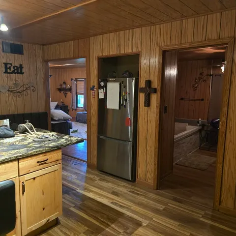 a kitchen with stainless steel appliances granite countertop a refrigerator and a stove