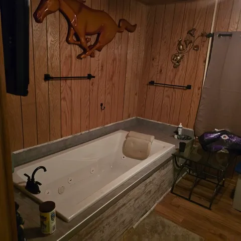 a bathroom with a tub and shower