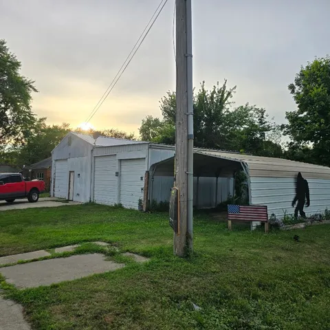 a backyard of a house with table and chairs