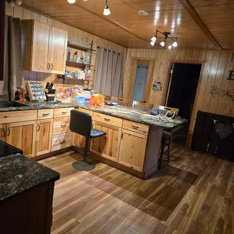 a kitchen with a sink appliances and cabinets