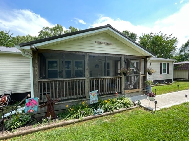 10047 Judy Road Lyles, TN 37098 - Photo 2 of 32 a front view of a house with garden