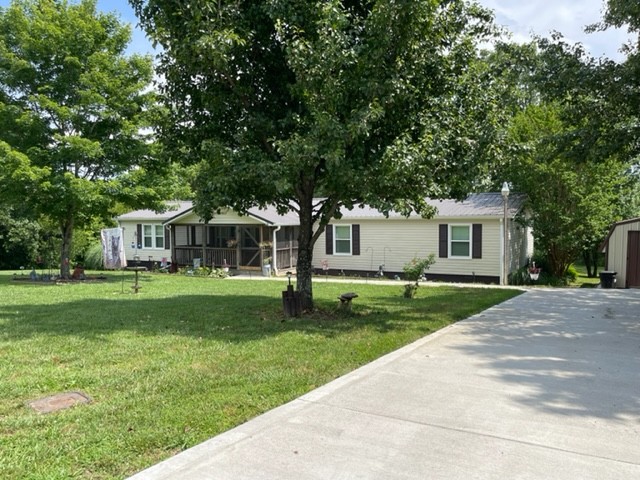 10047 Judy Road Lyles, TN 37098 - Photo 3 of 32 a front view of a house with garden