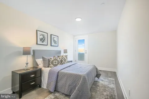 a bedroom with a bed and painting on the wall