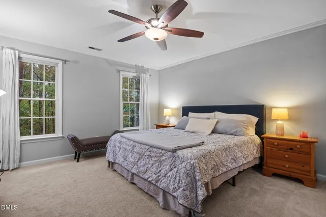 a bedroom with a bed and a large window