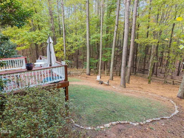 a view of a house with backyard and porch