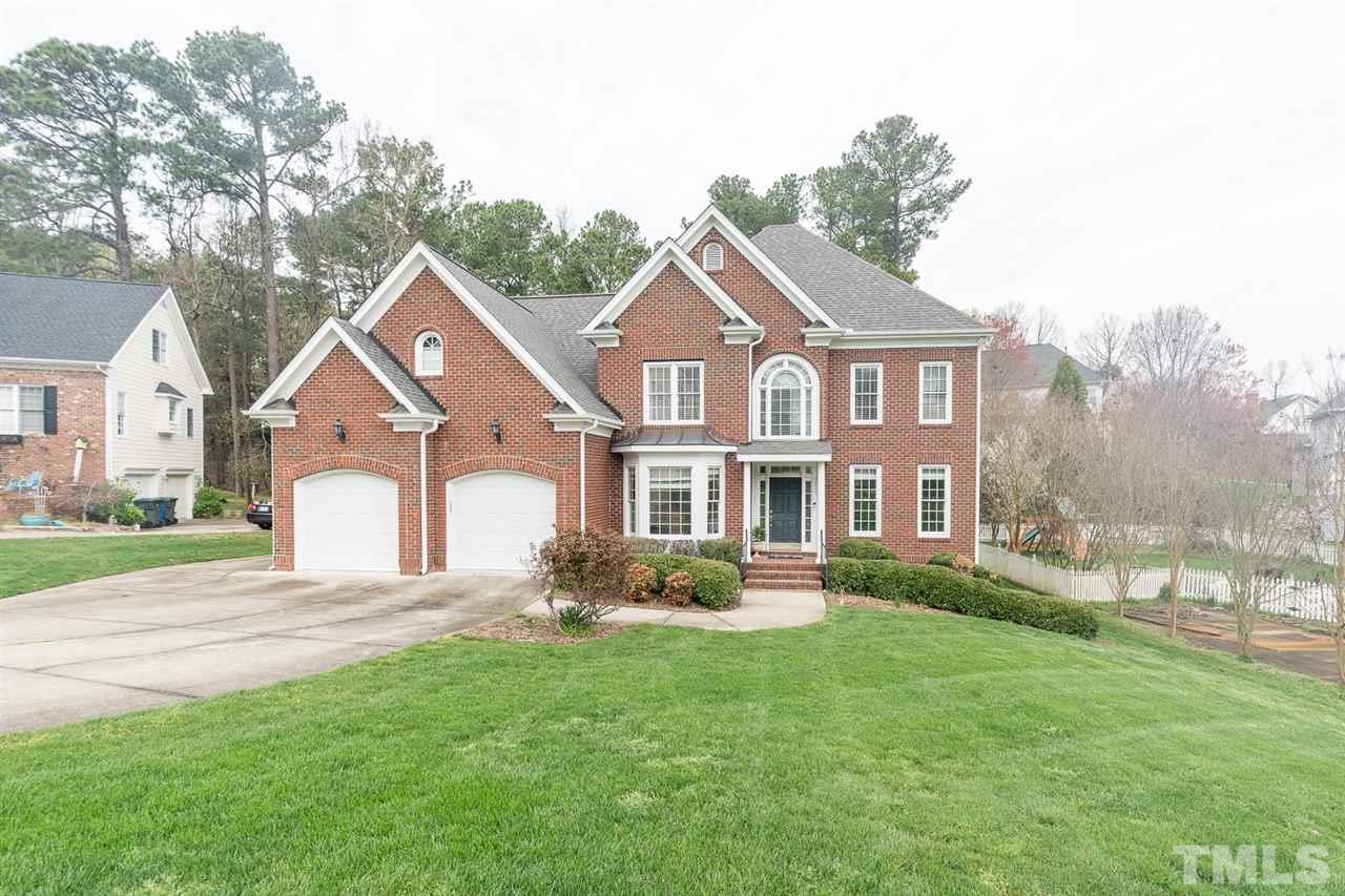 5209 Tallowtree Drive Raleigh, NC 27613 - Photo 1 of 22 a front view of a house with a yard and trees