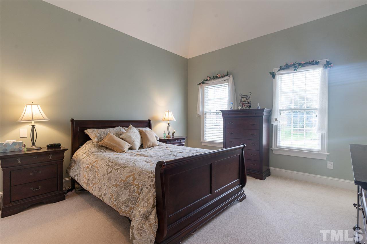 5209 Tallowtree Drive Raleigh, NC 27613 - Photo 11 of 22 a bedroom with a bed and a window