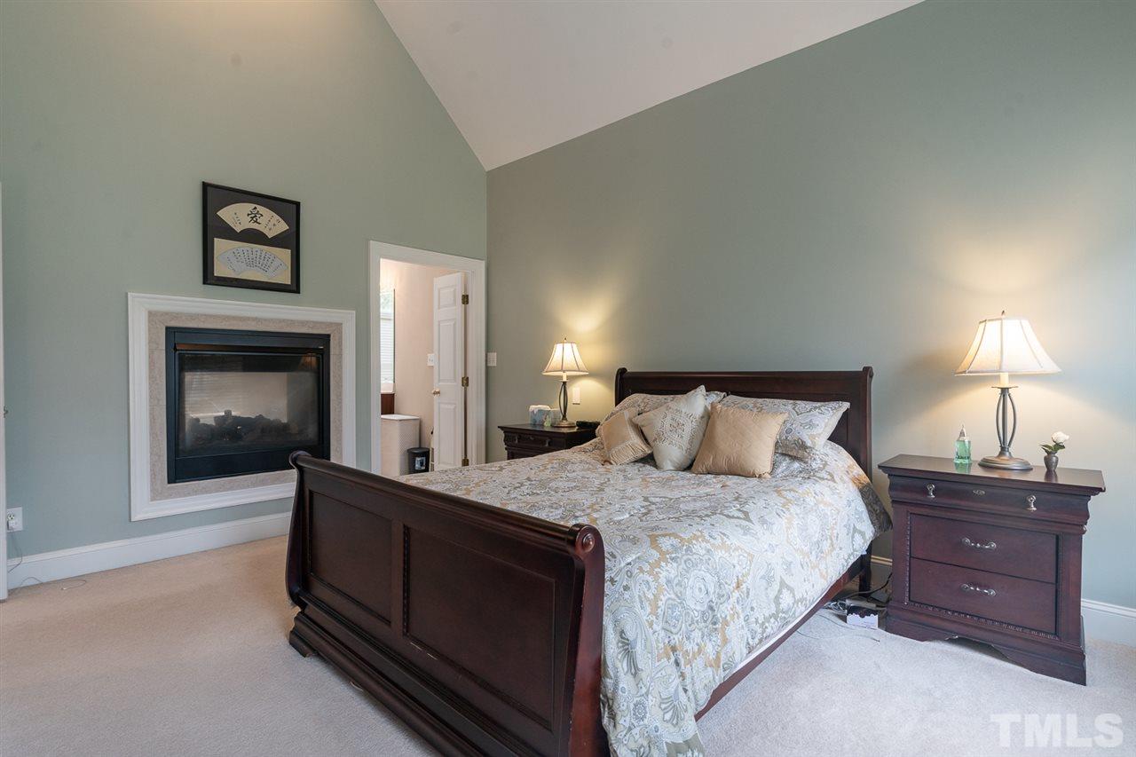 5209 Tallowtree Drive Raleigh, NC 27613 - Photo 12 of 22 a bedroom with a bed and a lamp on dresser