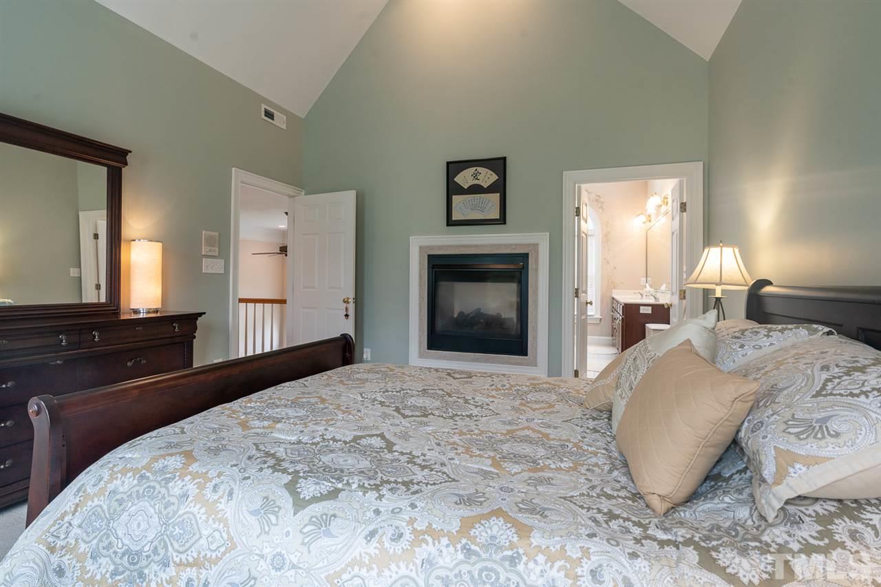 5209 Tallowtree Drive Raleigh, NC 27613 - Photo 13 of 22 a bedroom with a large bed and a dresser