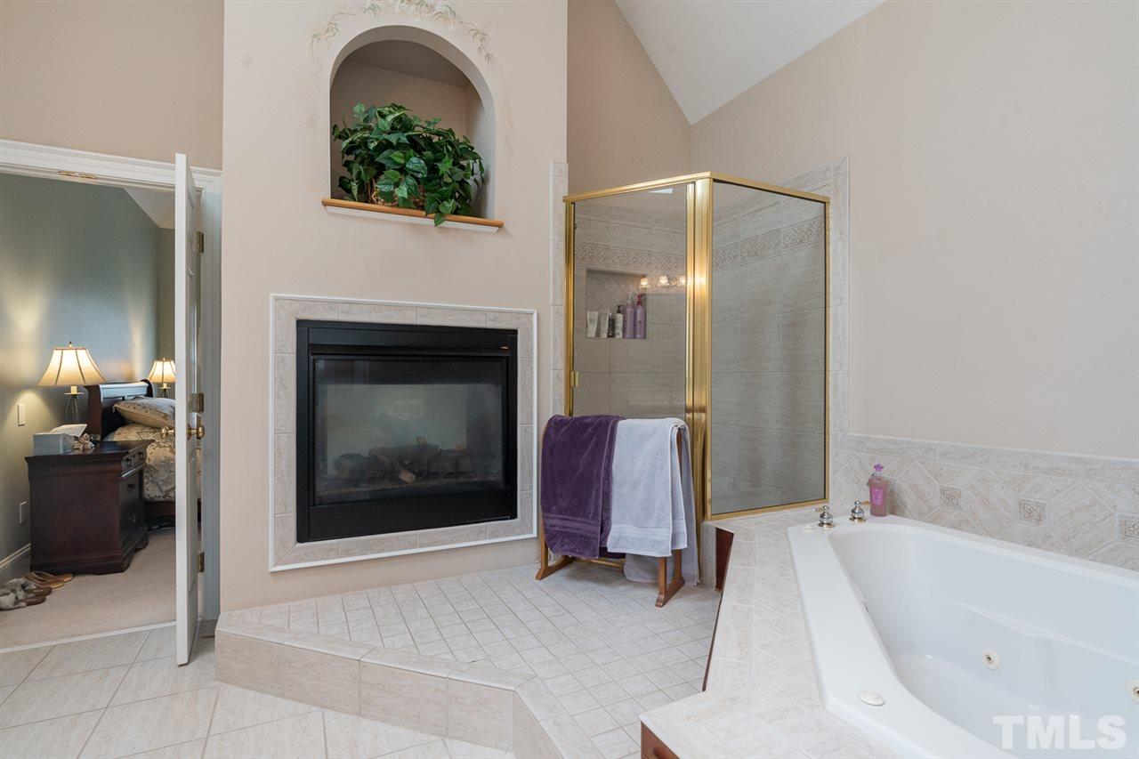 5209 Tallowtree Drive Raleigh, NC 27613 - Photo 14 of 22 a bathroom with a tub sink and mirror