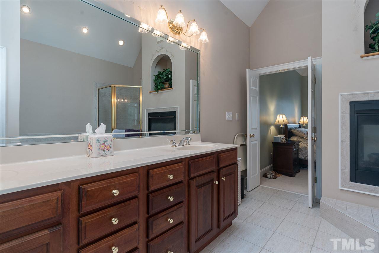5209 Tallowtree Drive Raleigh, NC 27613 - Photo 15 of 22 a spacious bathroom with a double vanity sink and a mirror