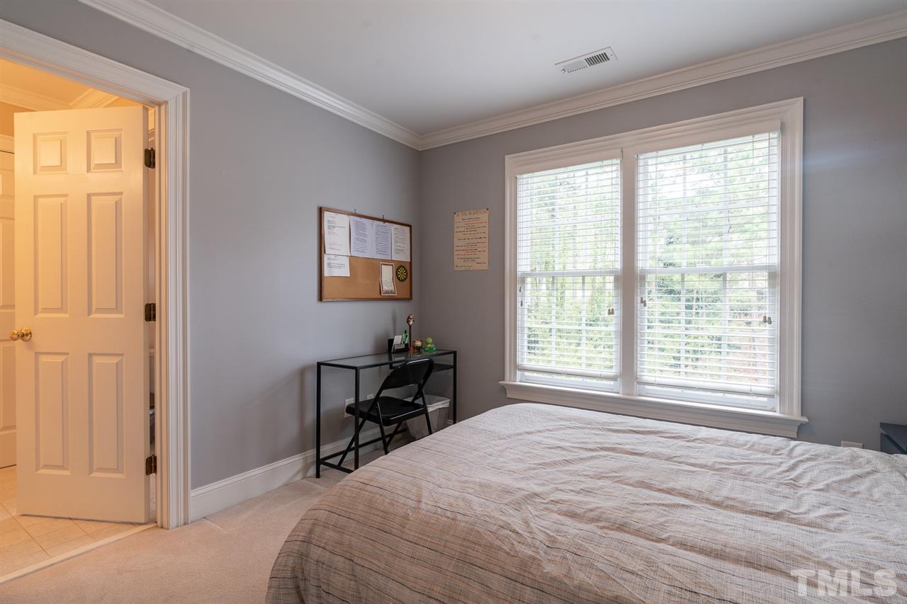 5209 Tallowtree Drive Raleigh, NC 27613 - Photo 16 of 22 a bedroom with a bed and a window