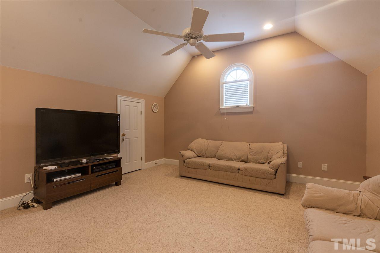 5209 Tallowtree Drive Raleigh, NC 27613 - Photo 17 of 22 a living room with furniture and a flat screen tv