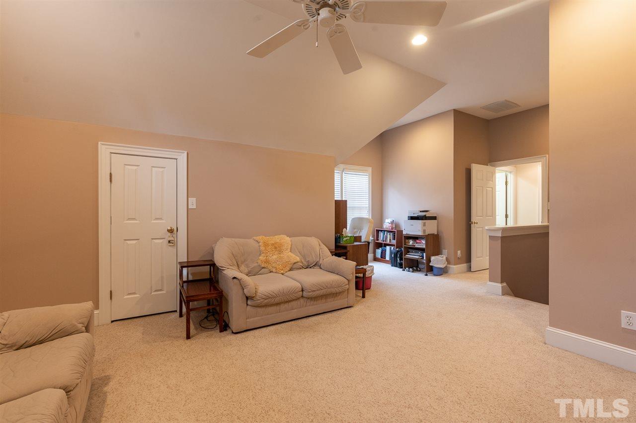 5209 Tallowtree Drive Raleigh, NC 27613 - Photo 18 of 22 a living room with furniture and white walls
