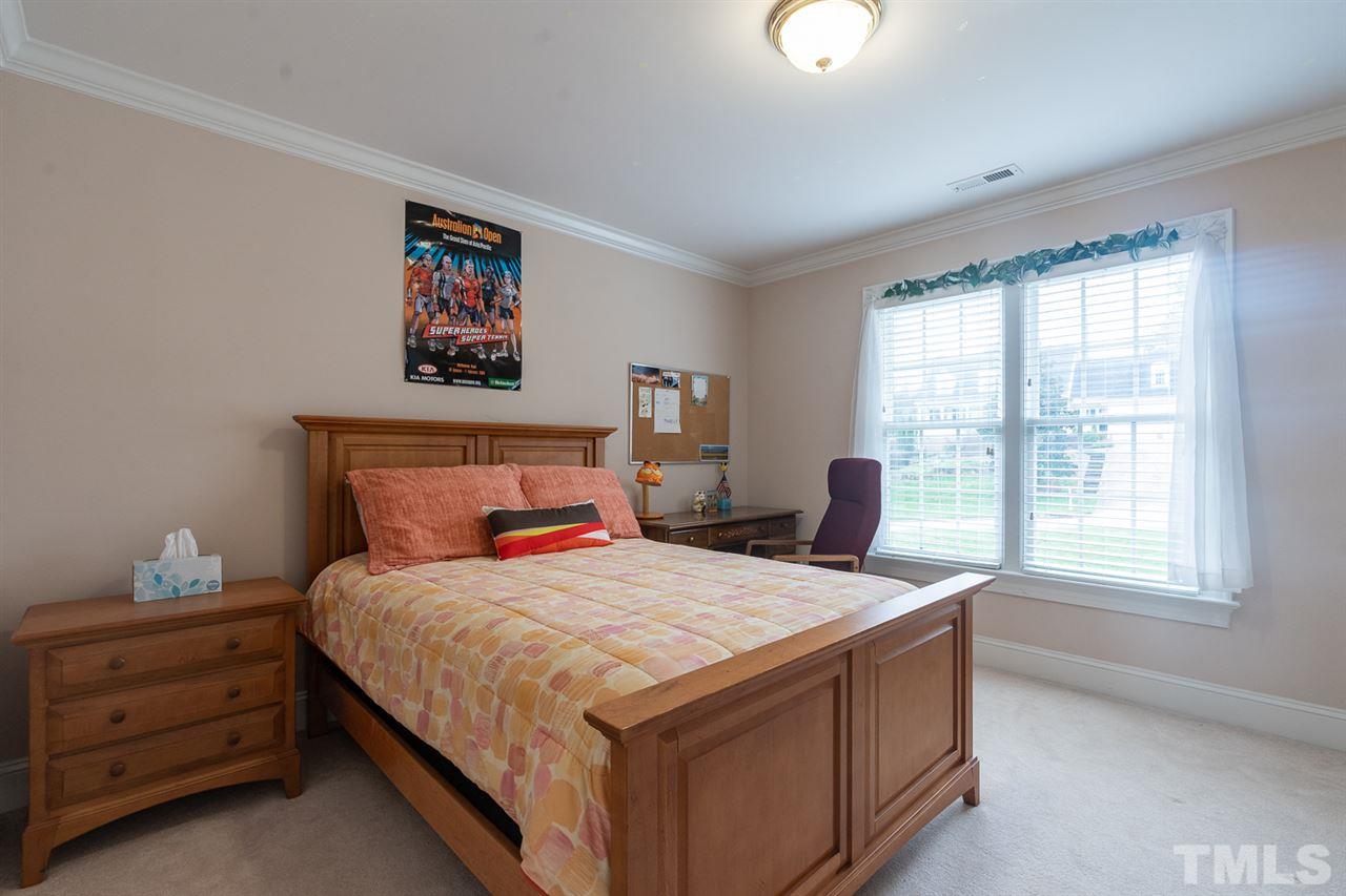 5209 Tallowtree Drive Raleigh, NC 27613 - Photo 19 of 22 a bedroom with a bed and a window