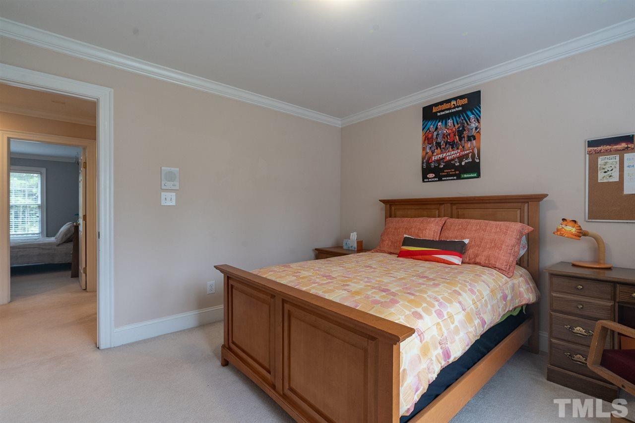 5209 Tallowtree Drive Raleigh, NC 27613 - Photo 20 of 22 a bedroom with a bed and a view of en suite bathroom