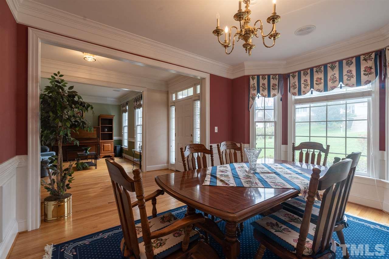5209 Tallowtree Drive Raleigh, NC 27613 - Photo 3 of 22 a view of a dining room with furniture window and wooden floor