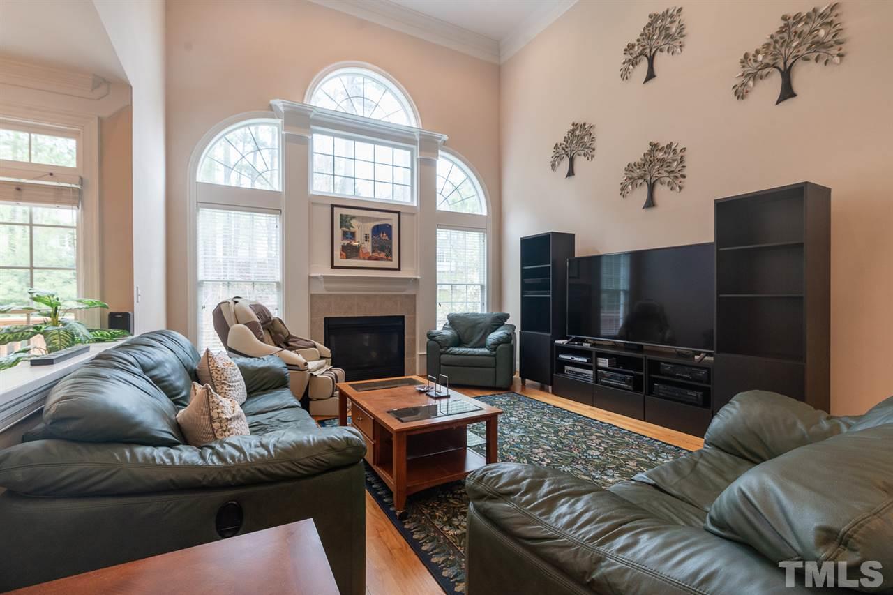 5209 Tallowtree Drive Raleigh, NC 27613 - Photo 4 of 22 a living room with furniture a flat screen tv and a large window