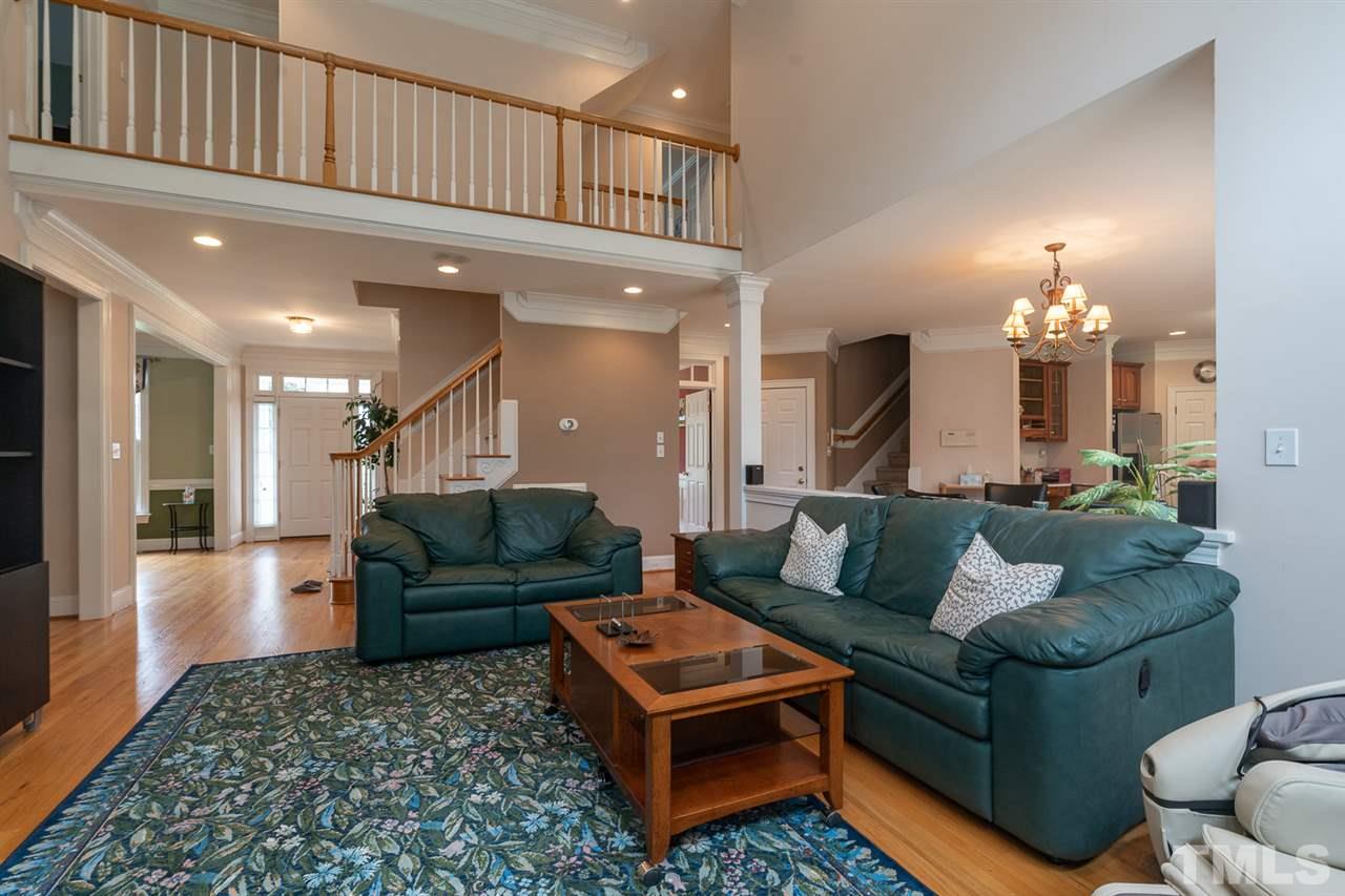 5209 Tallowtree Drive Raleigh, NC 27613 - Photo 5 of 22 a living room with furniture and a chandelier