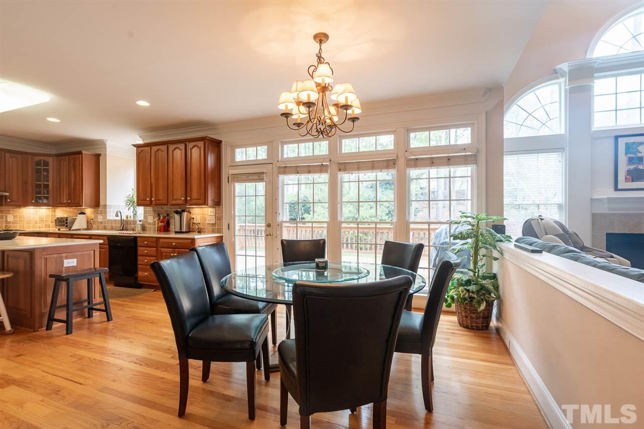 5209 Tallowtree Drive Raleigh, NC 27613 - Photo 6 of 22 a dining room with furniture a chandelier and wooden floor