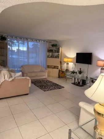 a kitchen with furniture a flat screen tv and a stove
