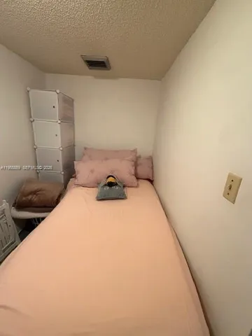 a bedroom with a bed and a cabinets