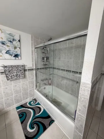 a bathroom with a bathtub and a shower