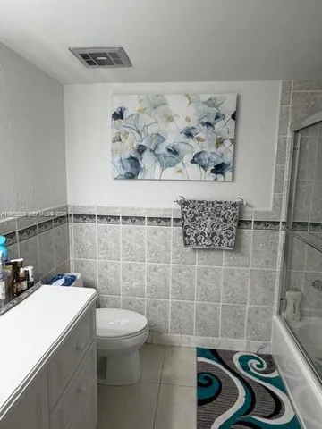 a bathroom with a sink a toilet and a shower