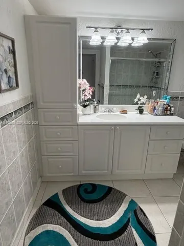 a room with a sink and chandelier