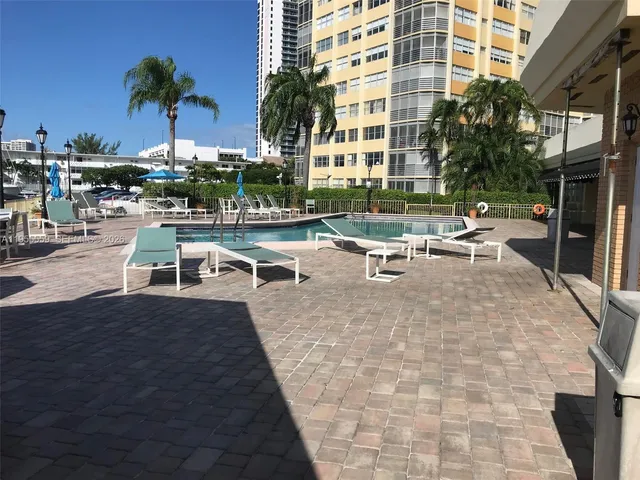 a view of a swimming pool with outdoor seating