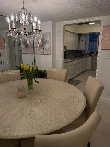 a dining room with furniture and chandelier