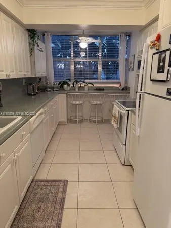 a kitchen with a sink a stove and cabinets