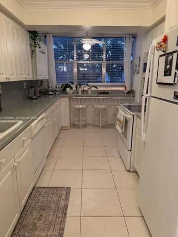 a kitchen with a sink a stove and cabinets