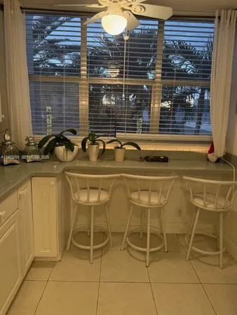 a view of a kitchen with a sink and cabinets