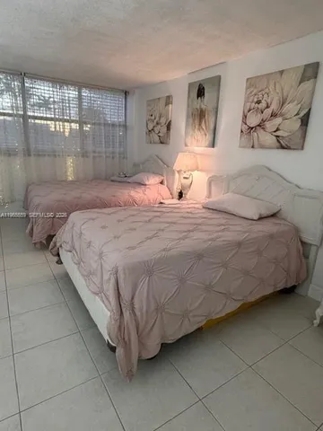 a bedroom with a bed and lamp