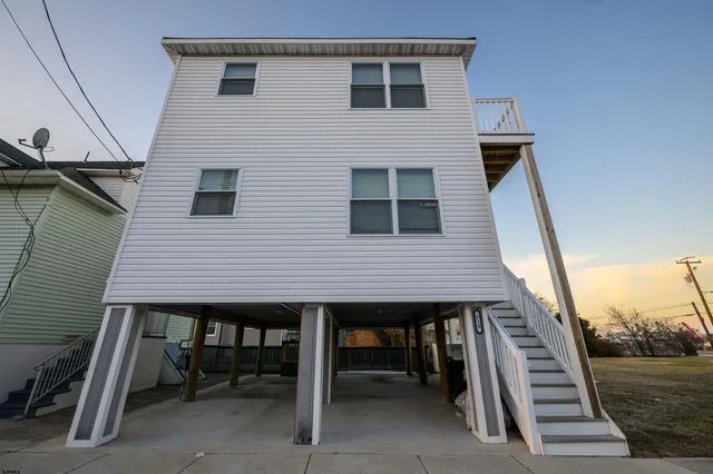 a terrace of a house with wooden floor and seating space
