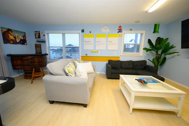 a living room with furniture and a pool table