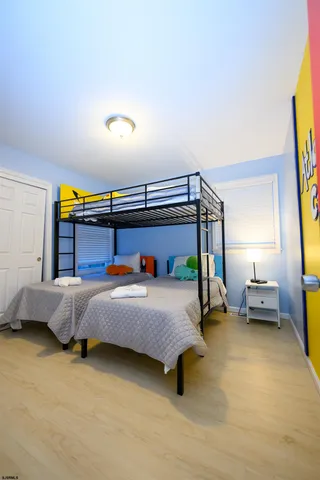 a bedroom with a bed and a night stand